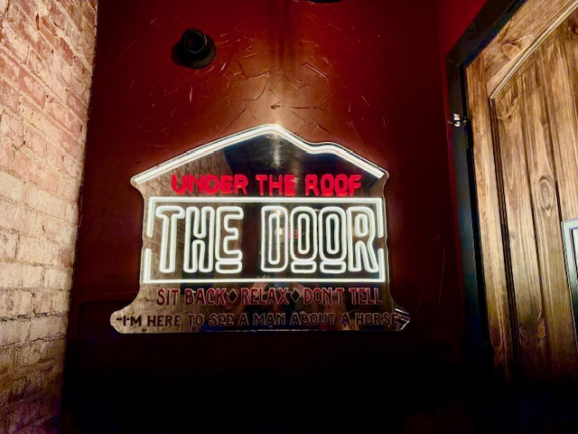 The Door speakeasy sign in downtown Ellijay GA hidden bar with secret entrance